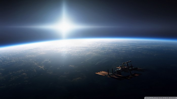 International Space Station orbiting Earth with bright sun