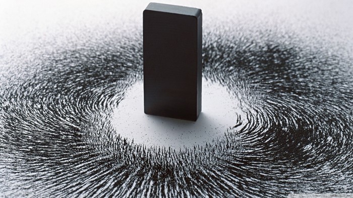 Magnet and iron filings showing magnetic field
