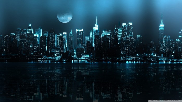 New York City skyline at night with moon reflection