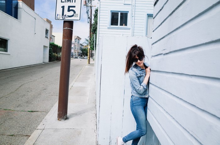 Woman in denim jacket and jeans on a street