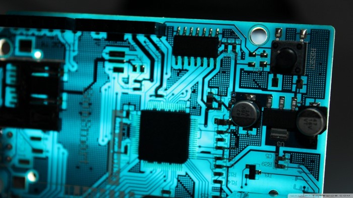 Close-up of a blue printed circuit board with electronic components