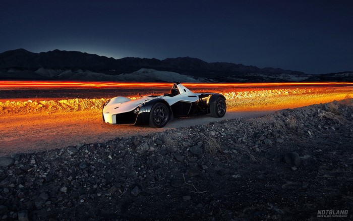 BAC Mono sports car on a dirt road at dusk
