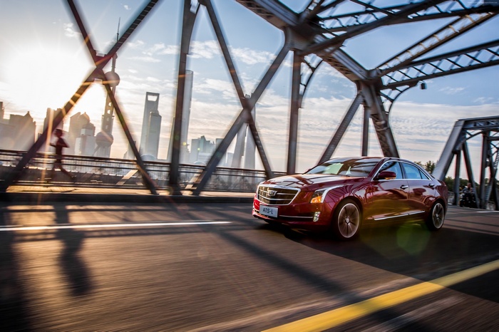 Red Cadillac ATS-L driving on a bridge in Shanghai