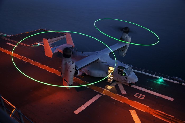 CV-22 Osprey aircraft on a ship deck at night