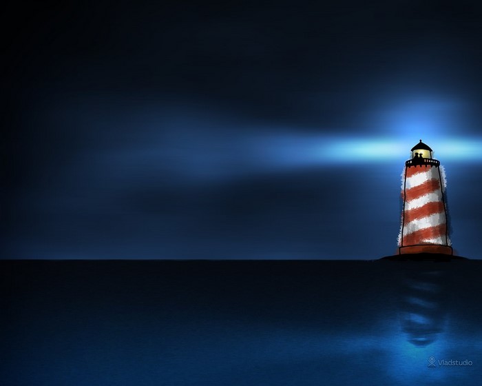 Lighthouse shining light across the dark sea at night