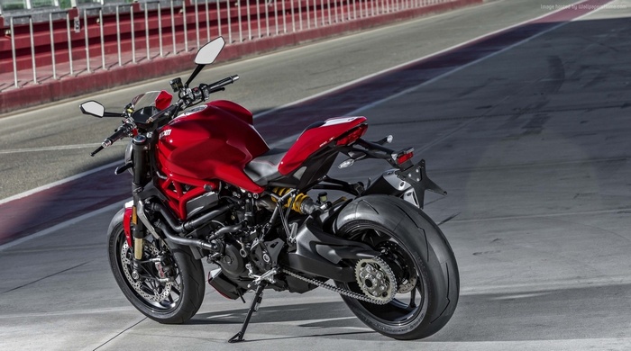 Red Ducati Monster 1200R motorcycle on asphalt