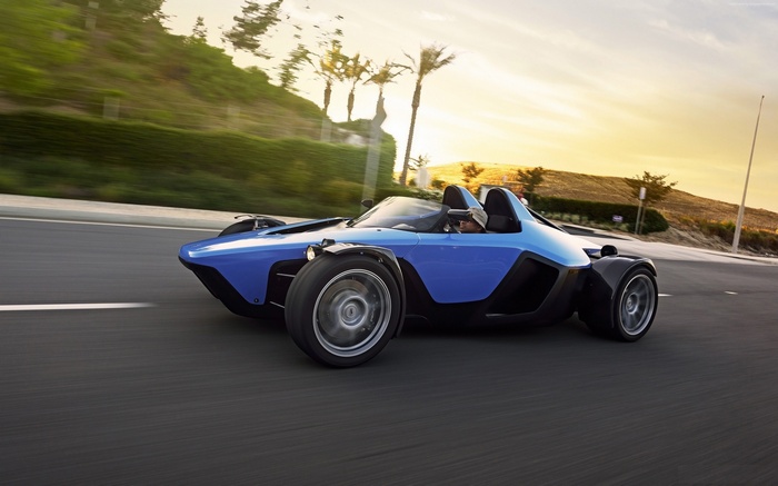 Blue Sector111 Drakan Spyder racing on a road