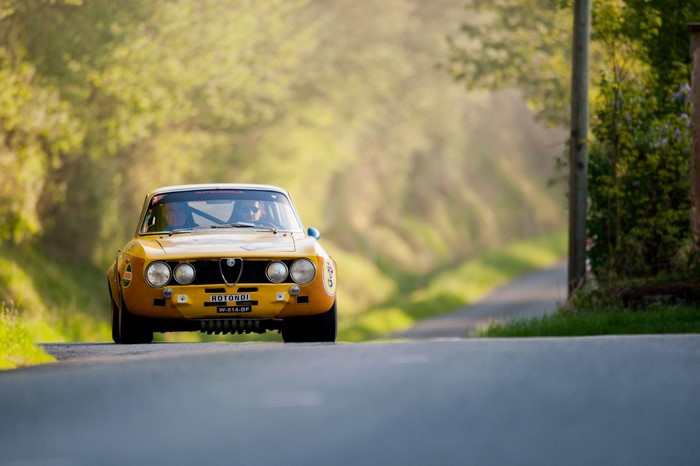 Yellow Alfa Romeo GT Veloce rally car on a road