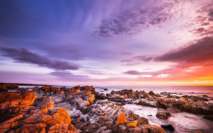 Rocky shore at sunset with colorful sky