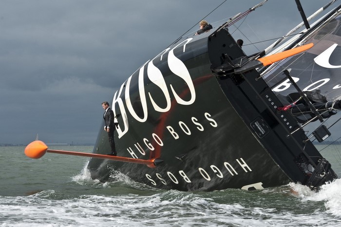 Man in suit on tilted Hugo Boss sailboat