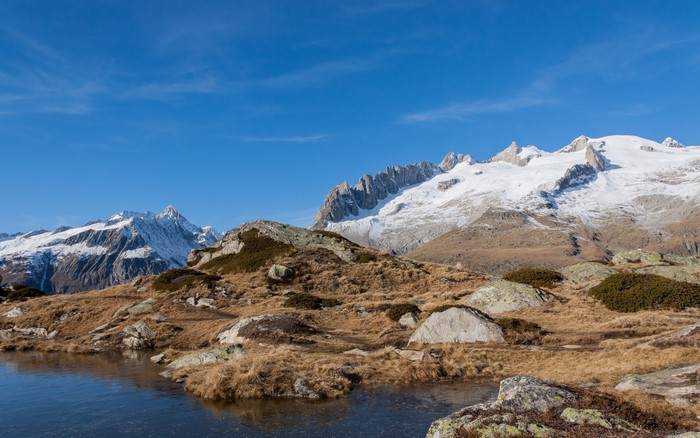 Snow-capped mountains and a frozen lake in the Alps