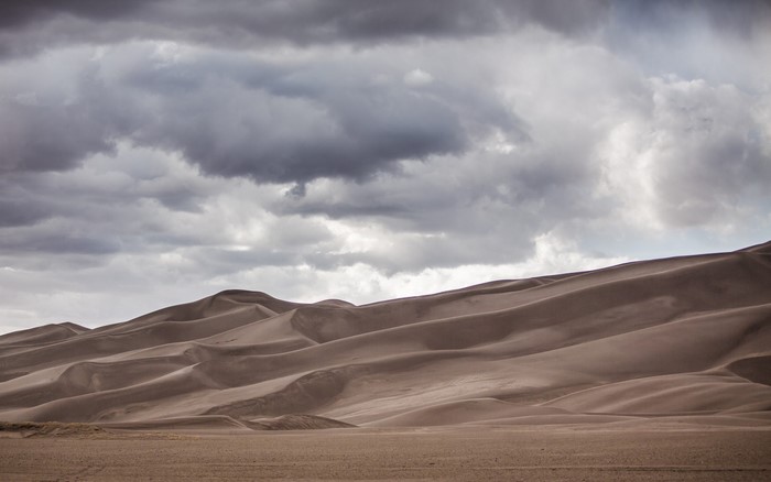 Sand dunes under a cloudy sky