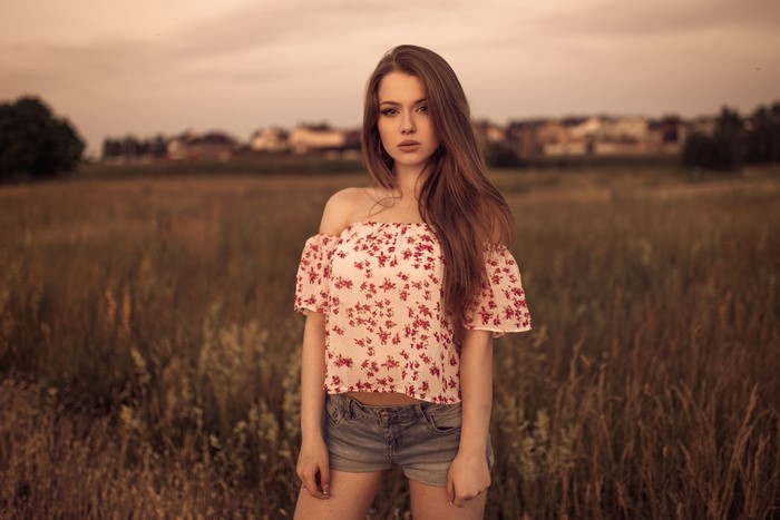 Young Woman in Floral Top and Denim Shorts Outdoors