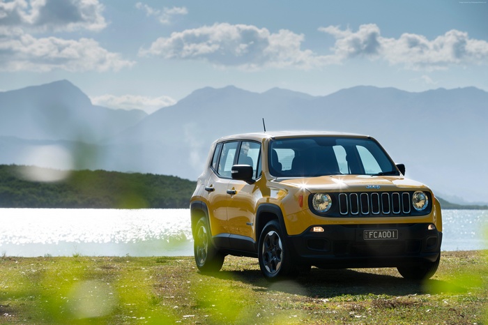 Yellow Jeep Renegade Sport parked by a lake
