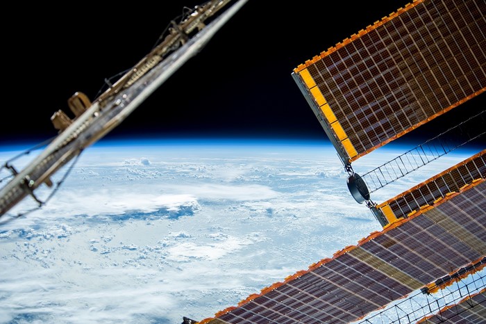 Space station solar arrays above Earth's atmosphere