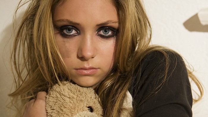 Emotional Portrait of a Crying Girl with Blue Eyes