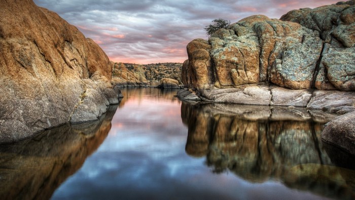 Rocky lake at sunset with dramatic clouds