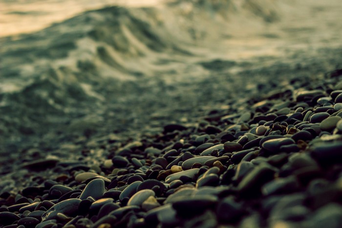 Pebble beach with waves crashing on shore