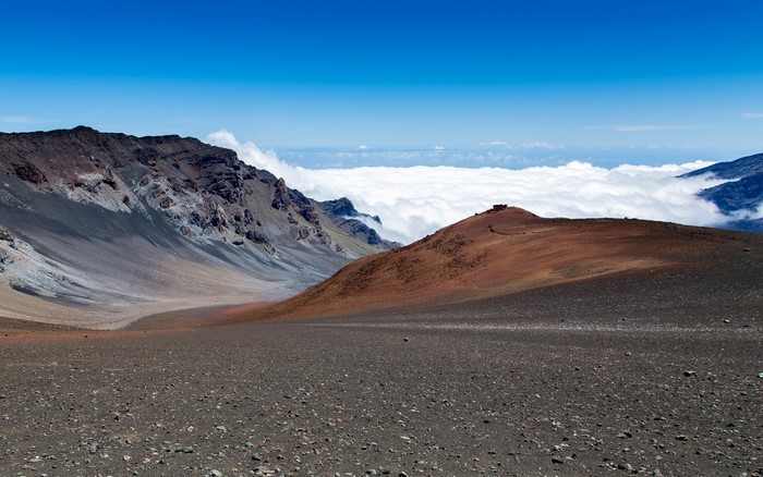 Volcanic crater landscape with clouds below