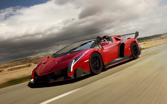 Red Lamborghini Veneno Roadster driving on a road
