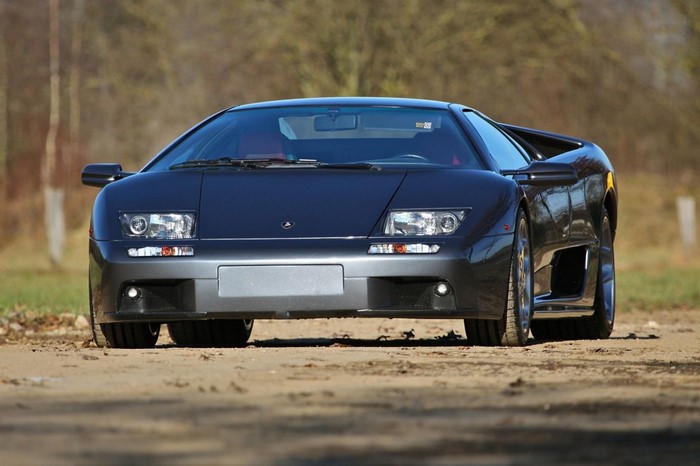 Dark gray Lamborghini Diablo VT 6.0 parked on a dirt road