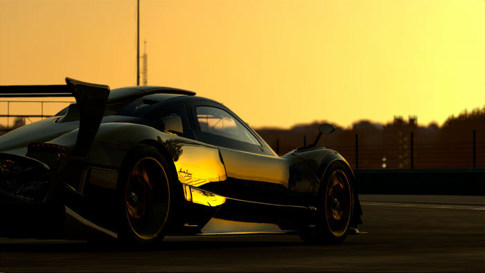 Golden sports car on a race track at sunset