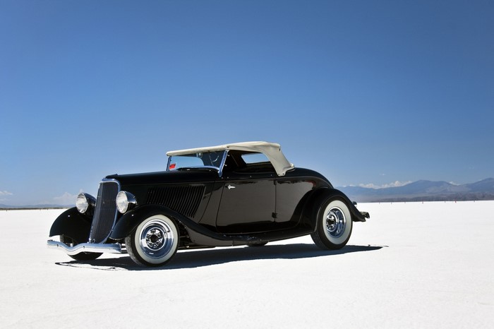 Black vintage convertible car on a salt flat