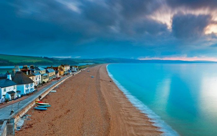 Coastal town and beach at dusk with calm sea