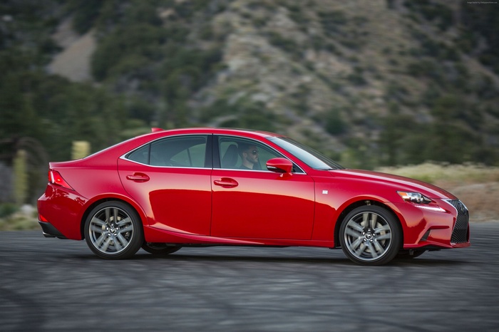 Red Lexus IS200T driving on a road