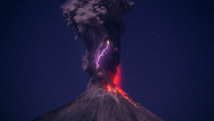 Volcano eruption with lightning at night
