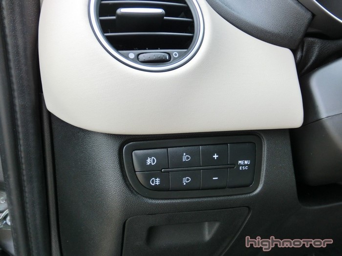 Car interior with dashboard controls and air vent