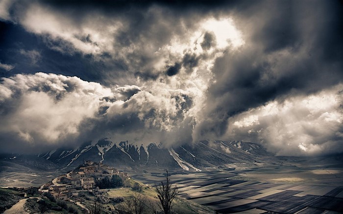 Dramatic Cloudscape Over Italian Mountain Village
