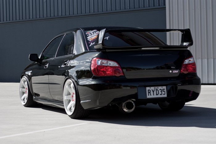 Black Subaru Impreza WRX STi with custom wheels
