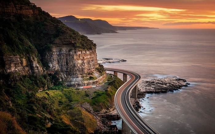 Sea Cliff Bridge at sunset over the ocean