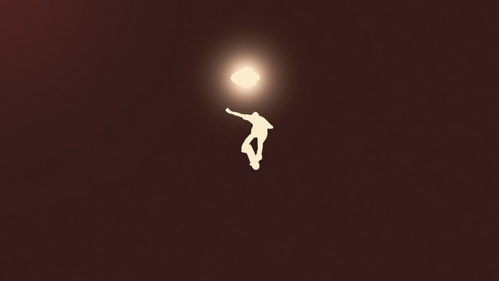 Silhouette of a skateboarder performing a trick
