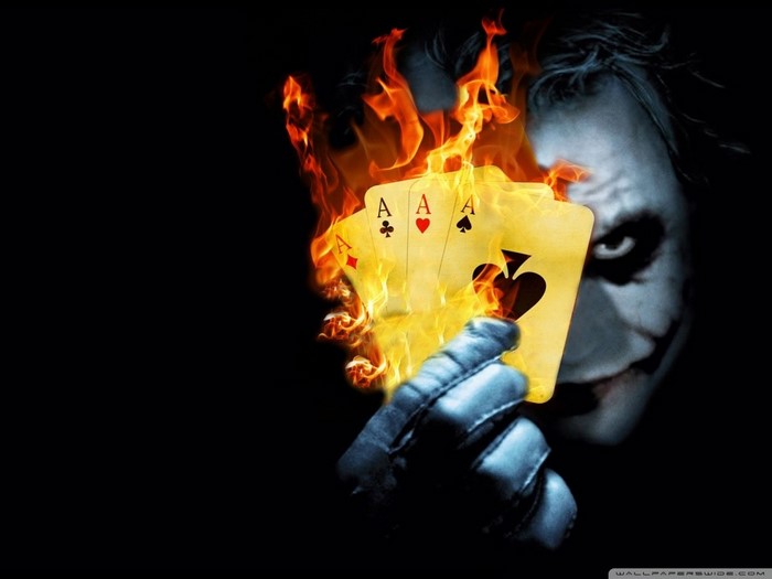 Joker holding flaming Aces