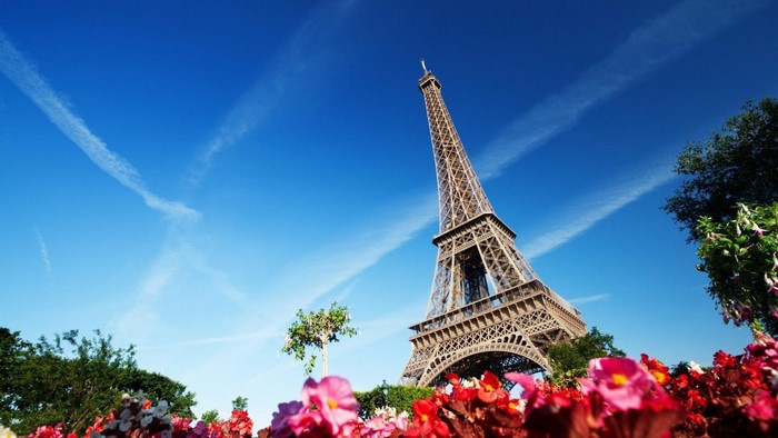 Eiffel Tower in Paris with flowers and blue sky