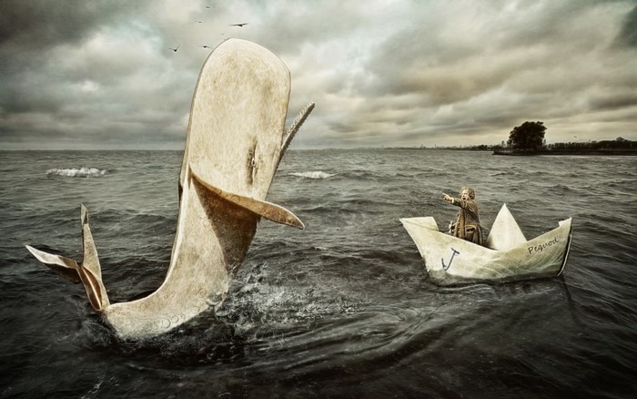 Man in paper boat confronts giant whale