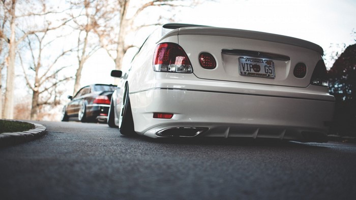 White Lexus GS with custom license plate parked on asphalt