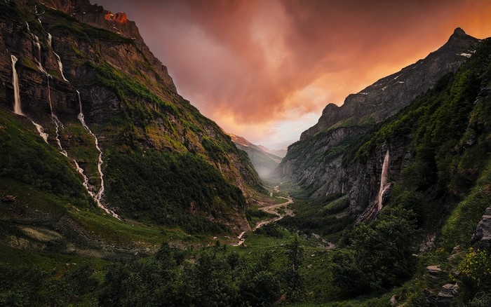 Mountain valley with waterfalls at sunset