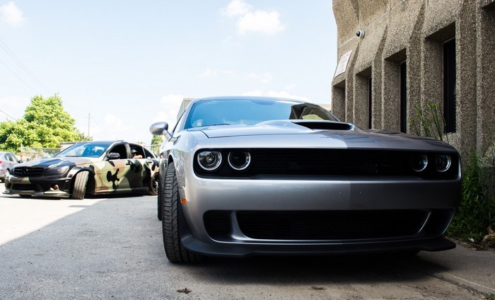 Silver Dodge Challenger and Camouflage Mercedes-Benz C63 AMG