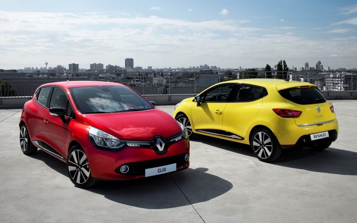 Red and yellow Renault Clio cars on rooftop