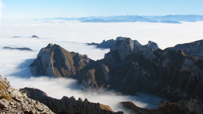 Mountain peaks above clouds in the Alps