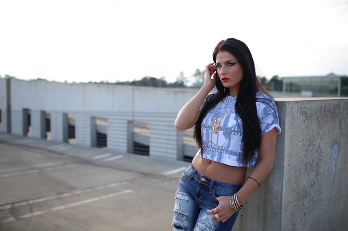 Woman in torn jeans and crop top posing