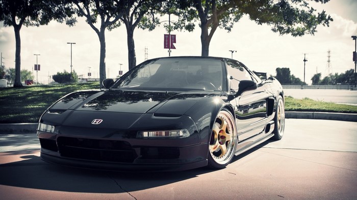 Black Honda NSX sports car with gold wheels