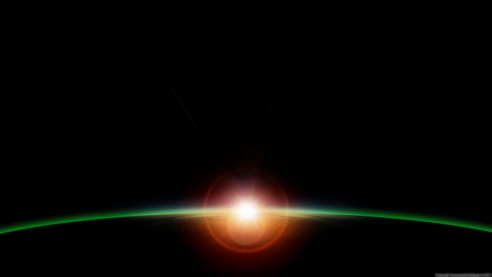 Sunrise over a planet with green atmosphere and lens flare