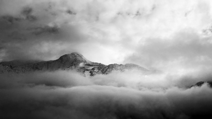 Misty mountains shrouded in clouds, black and white