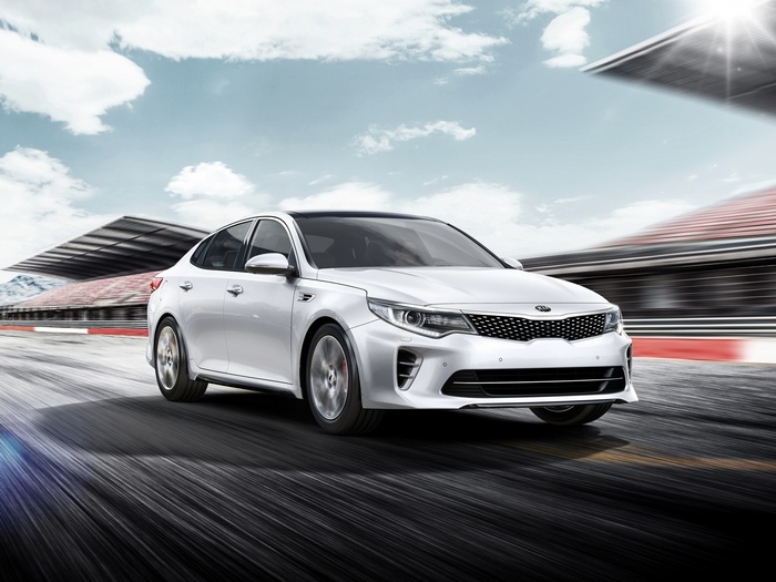 White Kia Optima GT driving on a race track