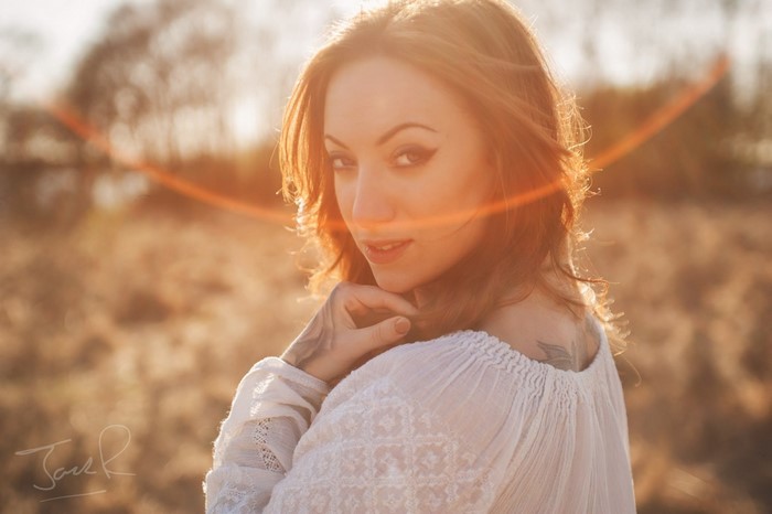 Woman with tattoo in sunlight
