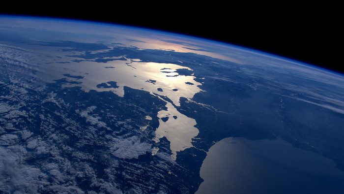 Earth from space showing landmasses and clouds